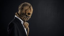 Fear and Halloween theme: a brutal killer in a mask on a dark background